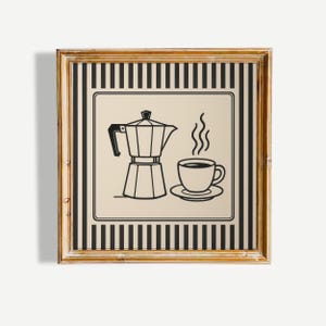 May include: A framed print with a black and white illustration of a coffee maker and a steaming cup of coffee. The image is set against a beige background with a black and white striped border, within a gold-coloured frame.