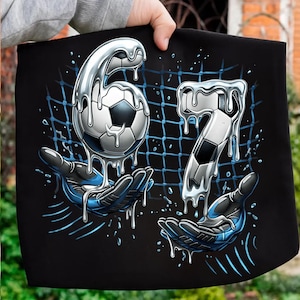 May include: Black graphic featuring a soccer ball and the numbers 6 and 7, rendered in a metallic, dripping style. The numbers and ball appear to be held by stylized hands with blue accents, set against a blue net.