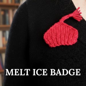 May include: A red knitted badge in the shape of a melting ice cream cone is pinned to a black sweater. The badge has a textured appearance and a small tassel at the top. The text "MELT ICE BADGE" is displayed at the bottom of the image.