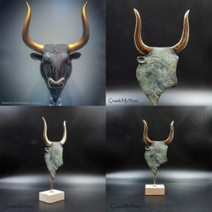 May include: A bronze sculpture of a bull's head with gold horns. The sculpture is on a wooden base and is displayed against a black background. The sculpture is a replica of a Minoan artifact from the Heraklion Archaeological Museum.