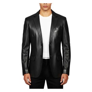 May include: A black leather blazer with a two-button closure, notched lapels, and a chest pocket. The jacket has a tailored fit and is worn over a white t-shirt and black pants. The sleeves have buttoned cuffs.