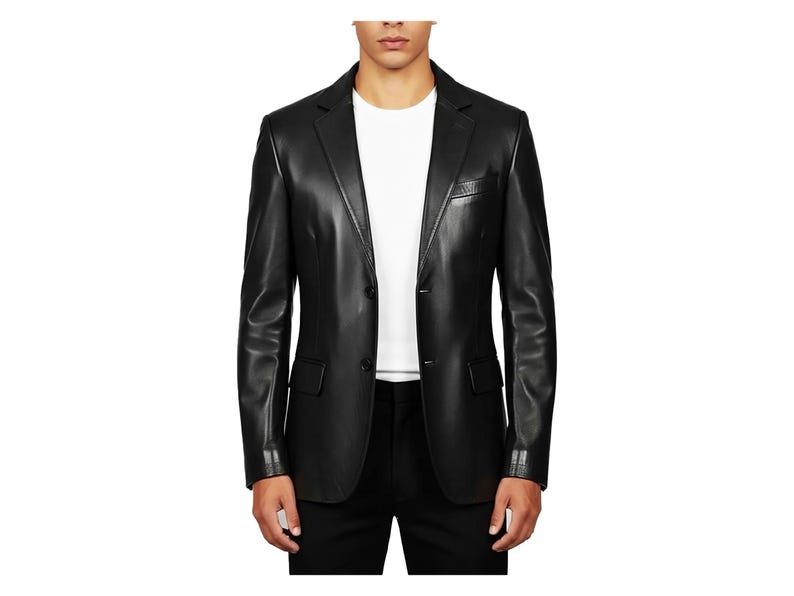 May include: A black leather blazer with a two-button closure, notched lapels, and a chest pocket. The jacket has a tailored fit and is worn over a white t-shirt and black pants. The sleeves have buttoned cuffs.