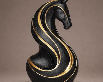May include: A black horse sculpture with gold accents. The horse has a curved neck and a rounded base. The gold accents are in the form of wavy lines that run along the horse's body. The sculpture is a decorative item.