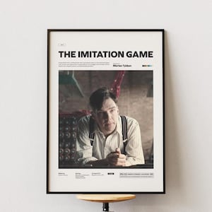 May include: Framed movie poster for "The Imitation Game" with a black border. The poster features a portrait of a man in a button-down shirt and suspenders. The movie title is at the top, with the director's name below.