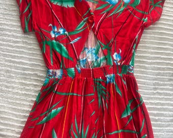 red floral patterned romper featuring a tropical print, short sleeves, and an open-back design with a single button closure. Medium