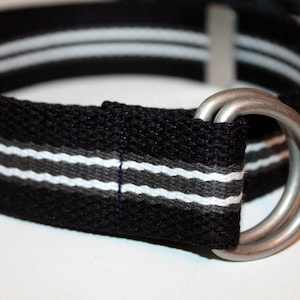 May include: A black and white striped fabric belt with a silver double-loop buckle.