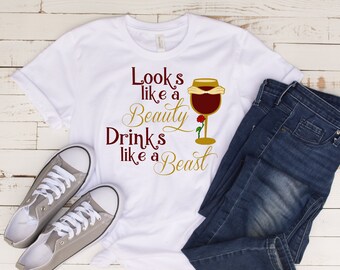 May include: White t-shirt with a red wine glass graphic and the text "Looks like a Beauty Drinks like a Beast".