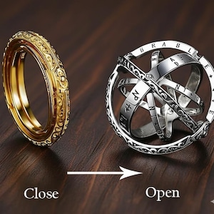 May include: A gold-colored ring with intricate scrollwork next to a silver-colored, openwork sphere ring. The sphere ring has engraved letters and numbers. The image shows the ring in the closed and open positions, with the words "Close" and "Open" below.