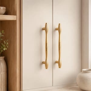 May include: Two vertical gold-toned cabinet handles with a fluted, textured design at the top and bottom. Each handle features the engraved black text "Bailey & Abbey" in a script font centered on the smooth middle section of the metal bar.