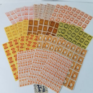 May include: A collection of vintage postage stamps, featuring a variety of designs and colors. The stamps are arranged in rows and columns, and some of them have been used. The stamps are in good condition and would be a great addition to any stamp collection.