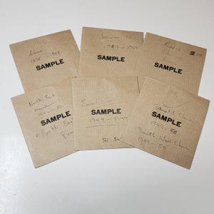 May include: Six square tan paper envelopes, each printed with the word SAMPLE in bold black capital letters. Each envelope features handwritten ink notations including geographic regions like China, Russia, and East China, along with specific date ranges.