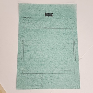 May include: A vintage teal-colored Frisco train order form. The form features a large rectangular space for writing, with horizontal lines and text including "Train Order No." and "Station." The Frisco logo is at the top.