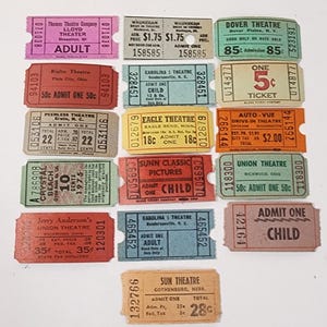 May include: A collection of vintage theater tickets in various colors, including pink, orange, and blue. The tickets feature text such as "ADULT," "CHILD," and theater names like "Thomas Theatre Company" and "Sunn Classic Pictures."
