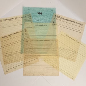 May include: A collection of vintage train order forms from various railway companies, including Western Maryland Railway Co., Penn Central Co., and Rock Island Lines. The forms are in various colors, with text and lines.