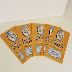 May include: Five yellow and blue Blue Chip Super-Ten Savings Books with a cartoon chipmunk on the front. The text "Spend stamps, Save money" is on the front of the book.