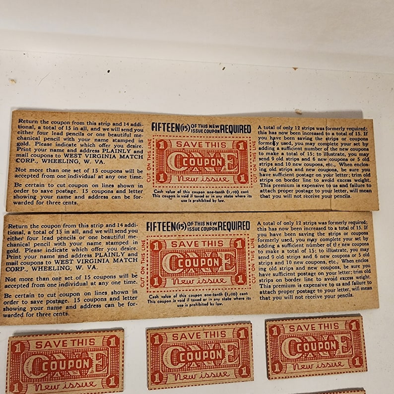 May include: A set of vintage coupons for pencils. Each coupon is red and white with the text "Save This Coupon" and "New Issue". The coupons require fifteen to be redeemed for a set of pencils.