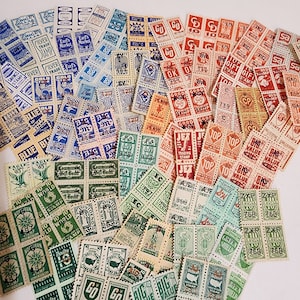 May include: A collection of vintage postage stamps featuring a variety of designs and colors. The stamps are arranged in a random pattern and include images of eagles, flags, and other patriotic symbols. Some of the stamps have text on them, such as "Gift Stamp" and "Big Value".
