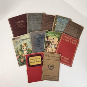 May include: A collection of vintage books with various titles, including "Free Will Baptist Hymnal", "Living Things", "Alice in Wonderland", "The Child-Center Speller", "Five Little Peppers", "Mr. Crewes Career", "Die Hochzeitsreise", and "Winston Churchill".