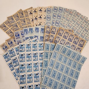 May include: A collection of vintage postage stamps featuring various designs, including a blue and white "Extra Value" stamp, a blue and white "Stop" stamp, and a brown and white "Pacific Mail" stamp.