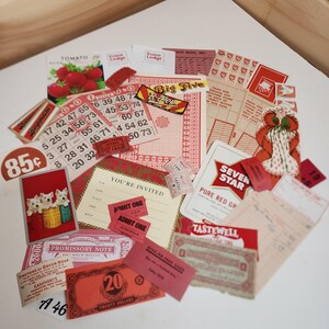 May include: A collection of vintage-style paper ephemera featuring red and cream tones. Items include bingo cards, admission tickets, a promissory note, a twenty-dollar bill, a tomato seed packet, playing cards, and various labels with text.