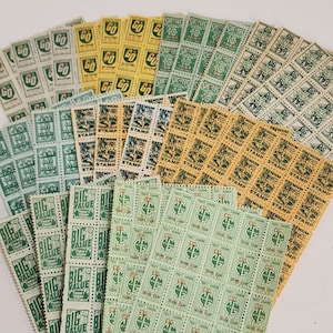 May include: A collection of vintage trading stamps, featuring various designs and colors. The stamps are arranged in rows and columns, with some overlapping. The stamps are printed with the words "Premium", "King Kong", "Big Value", "Thrift Stamp", and "Profit Sharing".