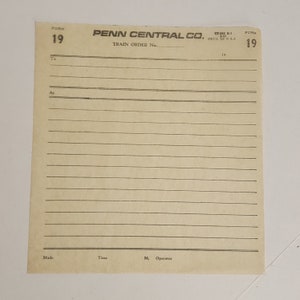 May include: A vintage Penn Central Co. train order form, Form 19, printed in the USA. The cream-colored paper has horizontal lines for writing and includes the text "Train Order No." and "To" and "At".