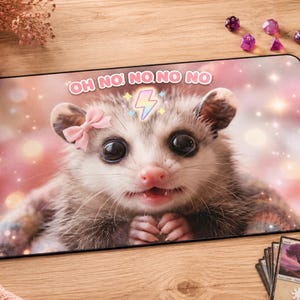 May include: A rectangular desk mat featuring a high-resolution image of a small opossum with large dark eyes, a pink bow on its head, and a lightning bolt icon above its forehead. The text "OH NO NO NO NO" is printed in white above the opossum.