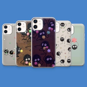 May include: Five phone cases with different designs of cartoon soot sprites holding stars. The cases have a clear, protective design, with the artwork visible on the back. The background is a solid blue.
