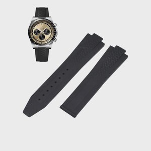 May include: A silver wristwatch with a gold-colored face and black subdials, paired with a black rubber watch strap and a separate black rubber strap. The watch has a textured black band.