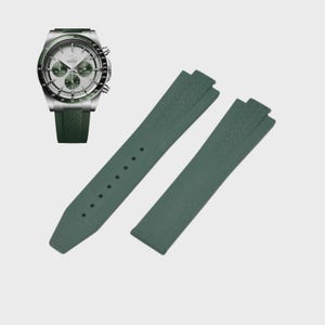 May include: A silver and green wristwatch with a green strap is displayed next to two green watch straps. The watch has a silver face with green subdials and a green bezel. The watch straps are a solid green color.