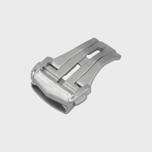 May include: A silver-colored watch clasp, featuring a curved design with two rectangular openings. The clasp is made of a shiny, metallic material and is designed to secure a watch band. The clasp is shown against a plain, light background.
