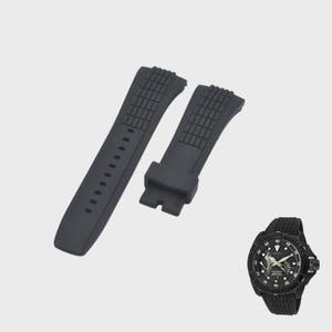 May include: Black watch straps and a black watch. The watch straps are made of a textured, flexible material. The watch has a black face with white and yellow markings and a black strap.