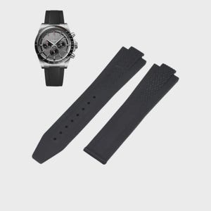 May include: A silver-toned chronograph watch with a black rubber strap and a matching black rubber watch strap replacement set. The watch face has multiple sub-dials and a textured gray background.