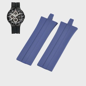 May include: A black chronograph watch with a black band is shown next to two blue watch straps. The watch face has white and black details with three sub-dials. The blue straps are rectangular with a raised section at one end.