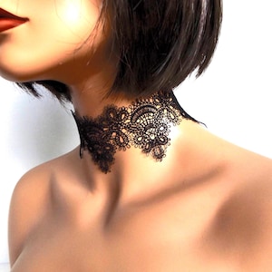 Wide black fabric lace choker on a mannequin facing Left.