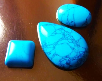 May include: Three turquoise stones, one square, one oval, and one teardrop shaped.