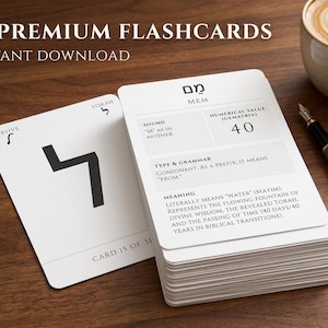 May include: A stack of white flashcards with black text and symbols, including the words "31 Premium Flashcards" and "Instant Download." A cup of coffee and a pen are also visible on the wooden surface.
