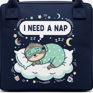 May include: A white ceramic mug with a black handle and the text "But First, Coffee" in a black, bold font. The mug is sitting on a wooden surface. The mug appears to be 12 ounces.