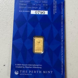 May include: A gold bar from The Perth Mint, displayed on a blue card. The card includes technical specifications, the bar number 0790, and the Perth Mint logo. The gold bar has a swan design.
