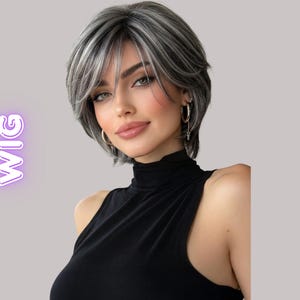 May include: A short, layered wig with a mix of gray and white strands. The wig has a side-swept fringe and is styled to frame the face. The text "EPIC COSPLAY WIG" is visible in the image.