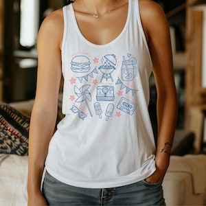 A woman wearing a white tank top with a graphic design of various summer-themed icons and objects, including a hamburger, a windmill, a hot dog, and a drink.