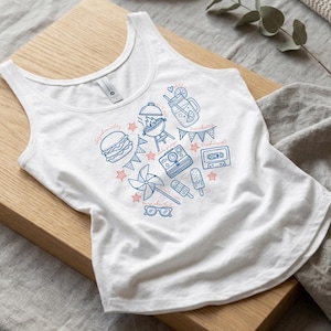 A white tank top with a graphic design featuring various icons and illustrations, including a hamburger, a windmill, a cassette tape, and other summer-themed elements.