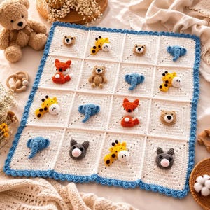 May include: A white crocheted blanket featuring a blue scalloped border and sixteen square panels. Each panel contains a small, three-dimensional crocheted animal head, including bears, foxes, giraffes, and blue elephants arranged in a grid.