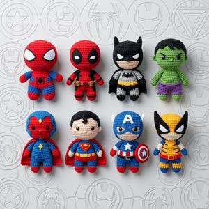 May include: Eight crocheted superhero dolls, including Spider-Man, Deadpool, Batman, Hulk, Vision, Superman, Captain America, and Wolverine. The dolls are brightly coloured and feature recognisable character details.