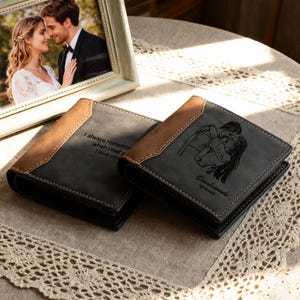 May include: Two gray wallets with brown accents and white stitching are displayed on a neutral surface. One wallet has the text "I always remember when I met you, I love you." The other wallet has a photo of a couple kissing.