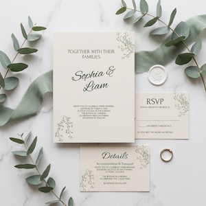 May include: A cream-colored wedding invitation suite featuring black text, including the names Sophia & Liam, an RSVP card, and a details card. The stationery is decorated with delicate green botanical line art and a white wax seal.