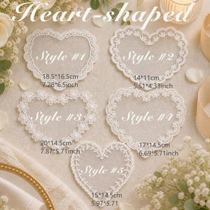 May include: Five white heart-shaped lace appliques labeled Style #1 through Style #5. Style #1 is 7.28 by 6.5 inches, Style #2 is 5.51 by 4.33 inches, Style #3 is 7.87 by 5.71 inches, Style #4 is 6.69 by 5.71 inches, and Style #5 is 5.97 by 5.71 inches.