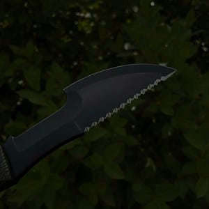 May include: A black knife with a serrated edge and a curved blade. The knife has a dark handle and a sharp point. The background is a blurred view of green foliage.