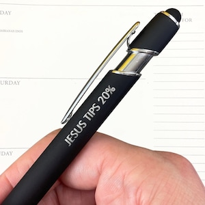 May include: A black pen with a silver clip and a stylus tip. The pen has the words "JESUS TIPS 20%" engraved on the side.