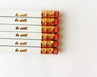 Be still  white engraved pencils cursive font. For peace of mind and calm. 3 pencils